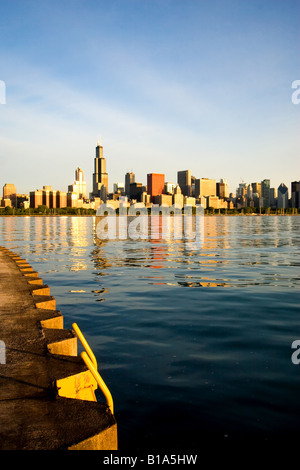 As the sun slowly rises on this spring morning, the famous skyline of Chicago, IL, begins to brighten. Stock Photo