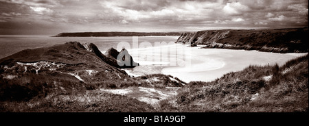 This panoramic view looks down over three cliffs to the left, tor to the right hand side and finally oxwich in the background Stock Photo