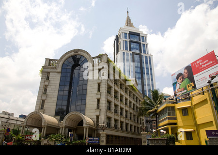 The changing skyline of a quickly modernising Bangalore. The highrise Bangalore Downtown building (UB City) towers over a bank. Stock Photo