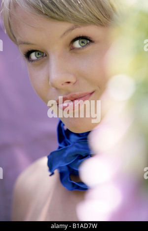 Portrait of young woman with ribbon around her neck Stock Photo