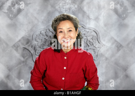oriental senior woman smiles Stock Photo