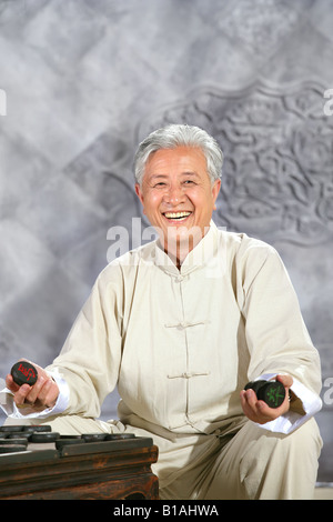 oriental senior adult playing chinese chess Stock Photo