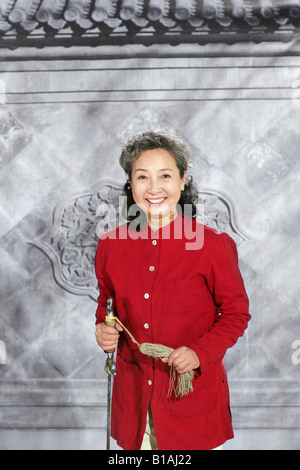 oriental senior woman dancing with sword Stock Photo
