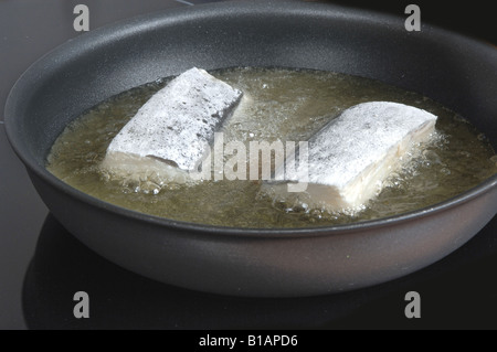 Frying floured cod Stock Photo - Alamy