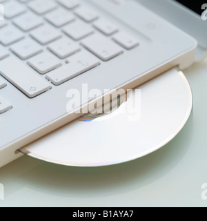 Compact disc in laptop Stock Photo