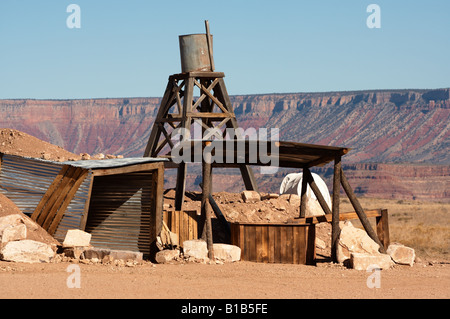 A wester scene with a mine shaft and water tower in the desert. Stock Photo
