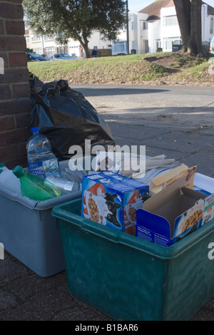 mixture of refuse boxes standing outside house waiting to be collected Stock Photo