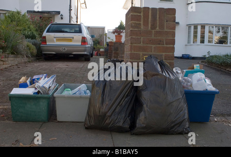 mixture of refuse boxes standing outside house waiting to be collected Stock Photo