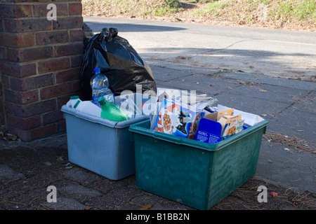 mixture of refuse boxes standing outside house waiting to be collected Stock Photo