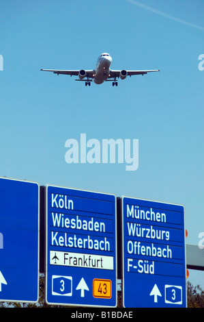Germany, Frankfurter Kreuz, Airplane over freeway Stock Photo