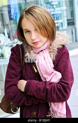 Teenage girl shivering in cold weather outside Stock Photo
