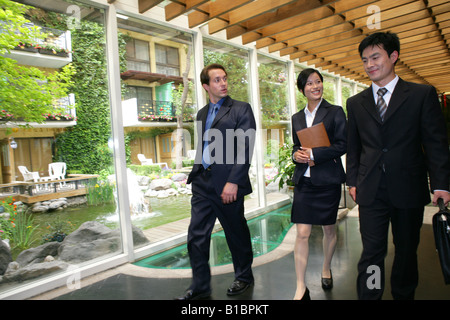 businesswoman and businessmen from different cultures talking in hotel Stock Photo