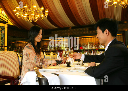 couple drinking wine in hotel restaurant Stock Photo