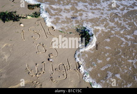 isle of wight written into the sand on the beach Stock Photo