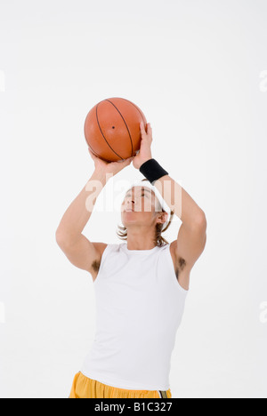 Basketball player shooting Stock Photo