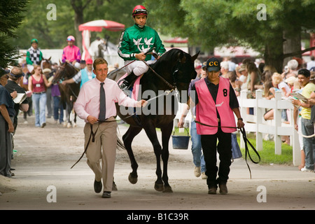 Trainers walking horses and jockeys from paddock to track Saratoga Race Course Saratoga Springs New York Stock Photo