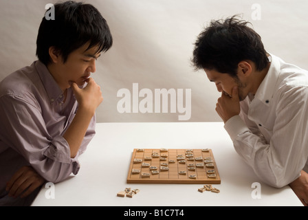Two young men playing Japanese chess Stock Photo