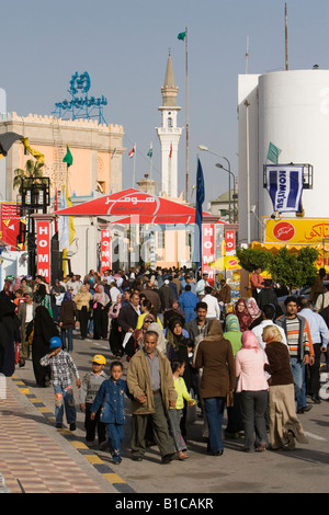 Tripoli, Libya, North Africa. Libyan Men, Women, Families at International Trade Fair. Clothing Styles. Minaret in Background. Stock Photo