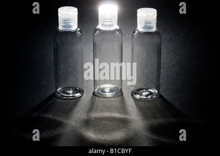 Three empty clear plastic travel dispenser bottles Stock Photo