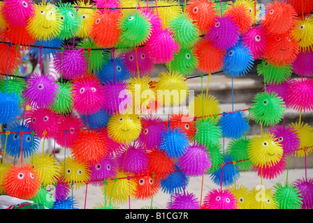 Children's plastic toys for sale on stall, Taormina, Messina Province, Sicily, Italy Stock Photo