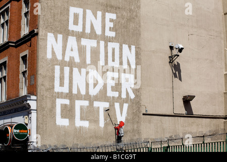 One Nation Under CCTV graffiti by Banksy. Newman Street, London, W1, England Stock Photo