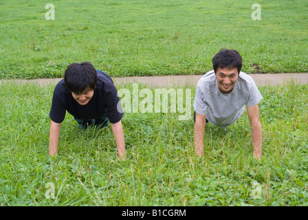 Two young men doing push-ups Stock Photo