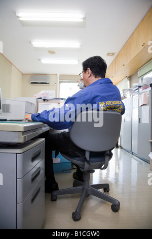 Mature man sitting in office Stock Photo