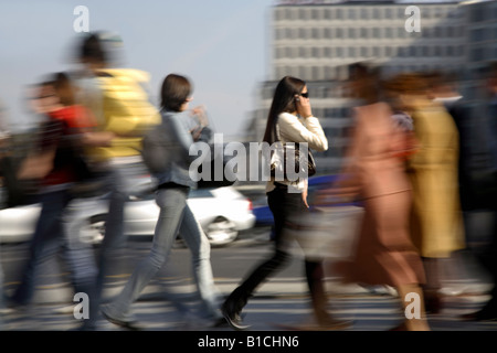 Woman talking on the phone in a crowd at Potsdam Square, Berlin, Germany Stock Photo