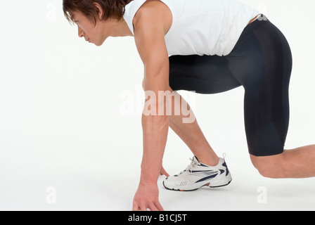 Young man ready to run Stock Photo