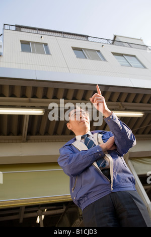 Mature man standing in front of warehouse Stock Photo