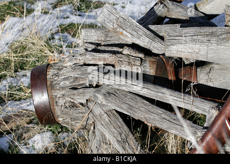 Old Broken Wooden wagon wheel in sagebrush Stock Photo