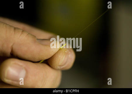 An electrician checks an optical fibre data cable during a fit-out at new London offices. Stock Photo