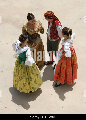 A discussion between three woman and a man in a traditional costumes Stock Photo