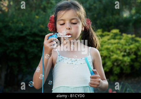 Child blows soap bubbles Stock Photo
