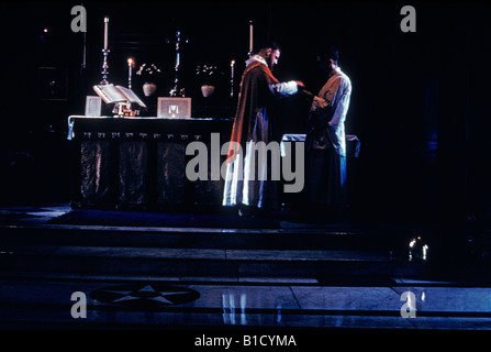 priest celebrating mass in front of altar Stock Photo