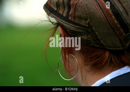 A redheaded woman in a wool cap from behind. Stock Photo