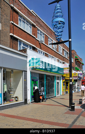 Upton Park Green Street shopping area  HBL bank with Lloyds TSB cash point machine ATM and lamp post spiral decoration Stock Photo