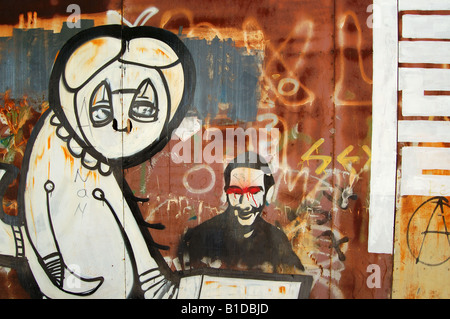 Graffiti on a rusty metal surface. Urban street art background. Stock Photo