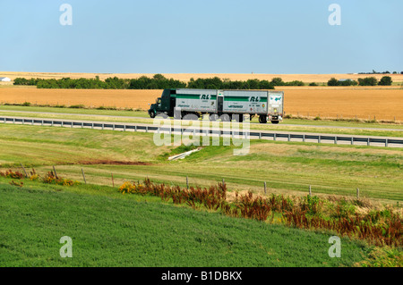Interstate 40 in central Oklahoma, heavily used by the trucking industry. Here it cuts between wheat and alfalfa fields. Oklahoma, USA. Stock Photo