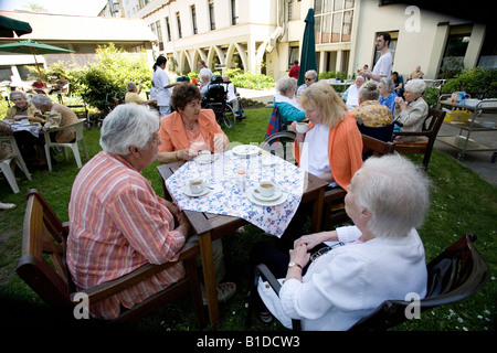 Residents of nursery home drinking coffee in a garden of a nursery home, Mainz, Germany Stock Photo