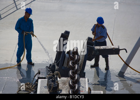 Washing the anchor chain as it is winched in on Cunard QE2 Stock Photo