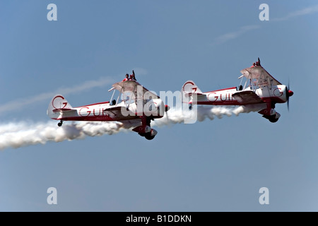 Two Boeing Stearman biplanes from Team Guinot perform their wingwalking feats at the Biggin Hill Airshow Stock Photo