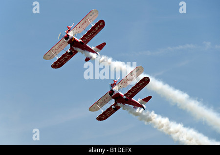 Two Boeing Stearman biplanes from Team Guinot perform their wingwalking feats at the Biggin Hill Airshow Stock Photo