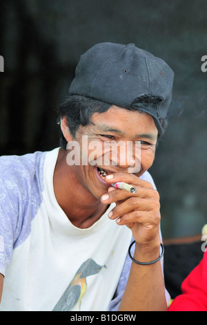A Mon tribal man smoking a local cigarette. Stock Photo