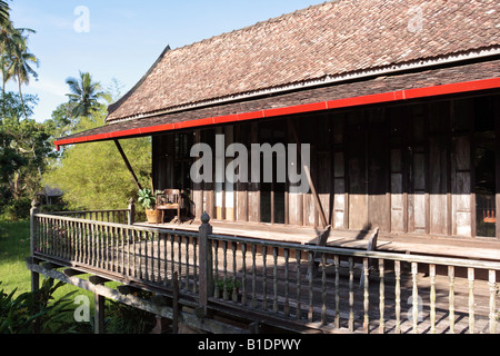 Traditional Malay house in Terengganu, Malaysia. The roof is made of baked clay tile. Stock Photo