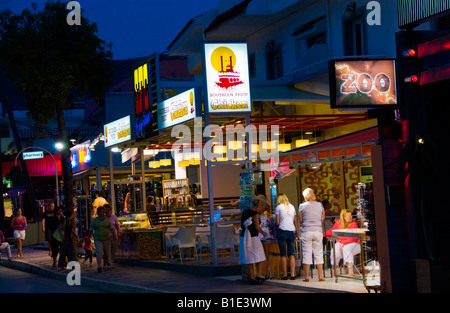 Night time on main street in Malia on the Greek Mediterranean island of Crete Stock Photo