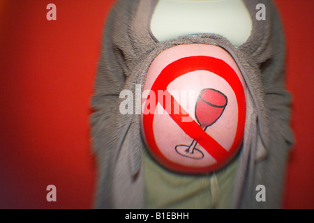 Pregnant woman dressed in robe with *no drinking* symbol painted on her stomach Alaska United States Stock Photo