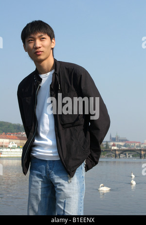 Young Asian man in a black jacket Stock Photo
