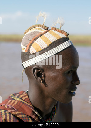 A finely decorated clay hairstyle of a young Dassanech man.The row of decorations on top of the head are ostrich feather holders Stock Photo