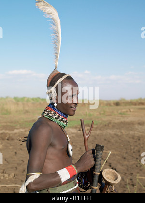 A smartly dressed Dassanech man.   His hairstyle and attire signify that he is about to marry. Stock Photo